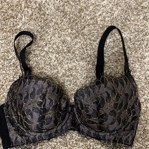 Beautiful black lace bra with gold trim.